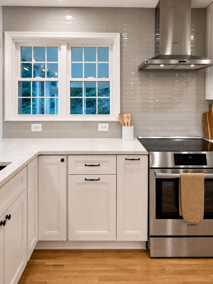Corner view of stainless steel appliances and white cabinetry in Burke kitchen remodel by Anchor Remodel