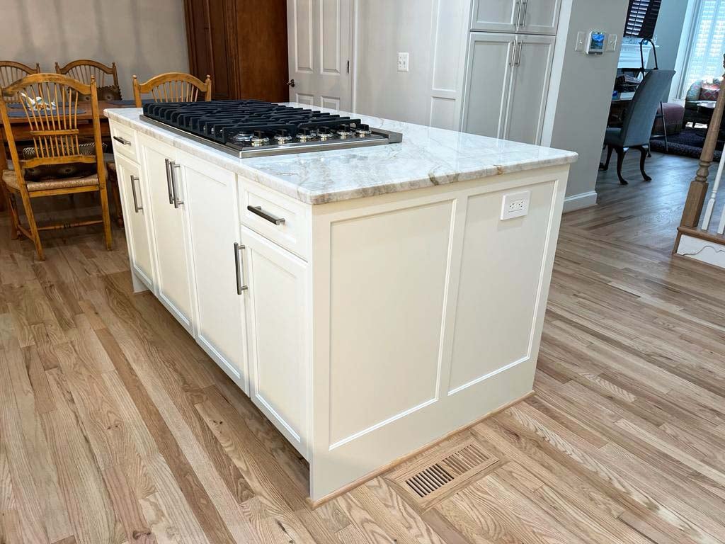Elegant kitchen island and hardwood floors in a remodel by Anchor Remodel in McLean, VA.