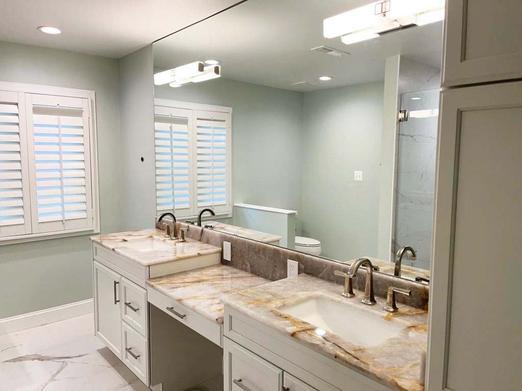 Modern vanity area with double sinks and chrome fixtures by Anchor Remodel in McLean, VA.