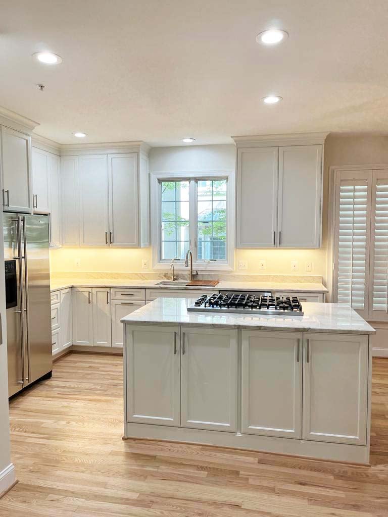 Open kitchen design with island cooktop and windowed sink area by Anchor Remodel in McLean, VA.