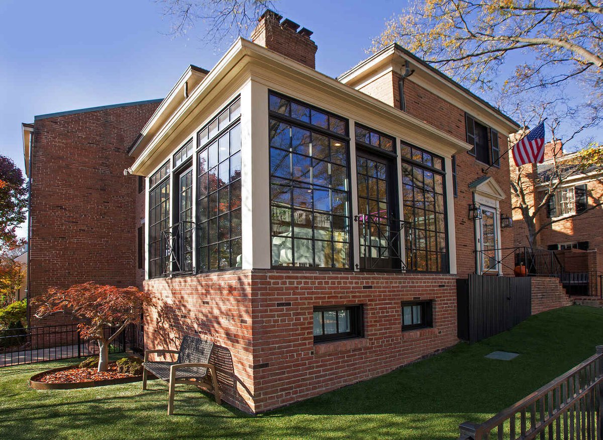 Angled view of sunroom addition with black grid windows by Anchor Remodel in Alexandria, VA