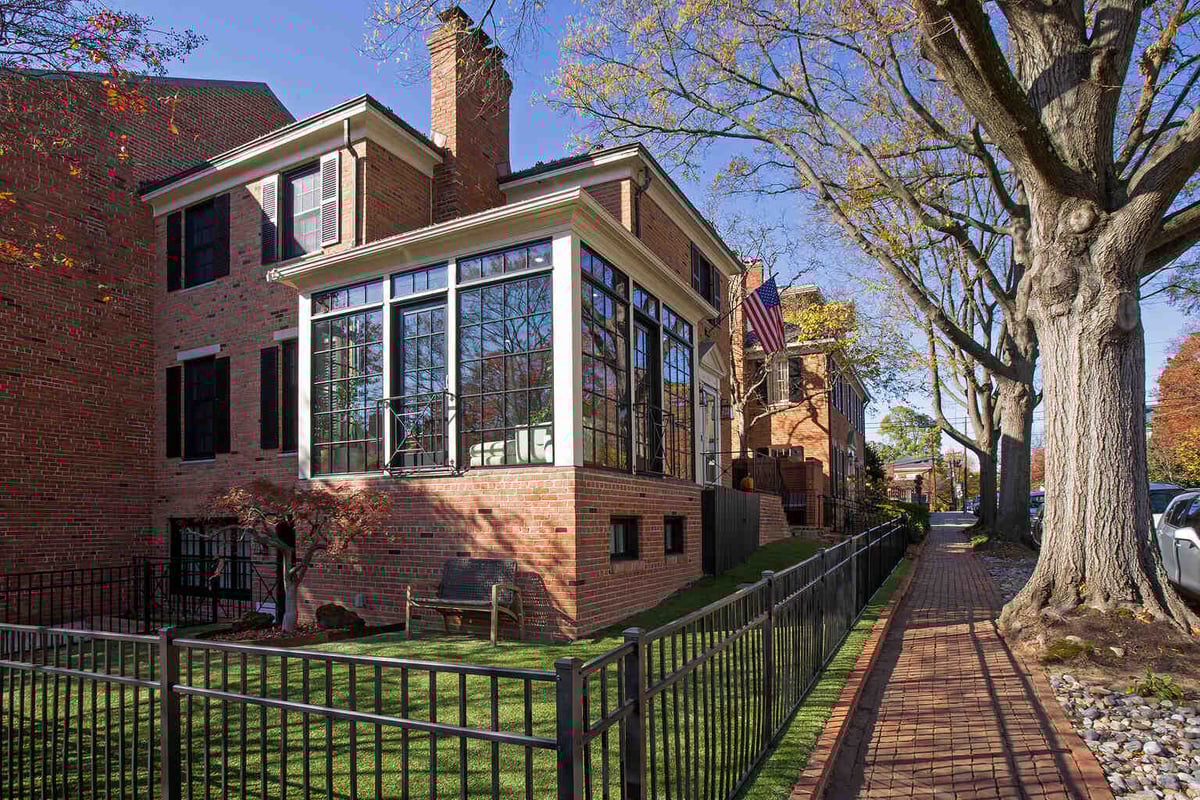 Architectural remodel with glass sunroom in traditional neighborhood by Anchor Remodel in Alexandria, VA