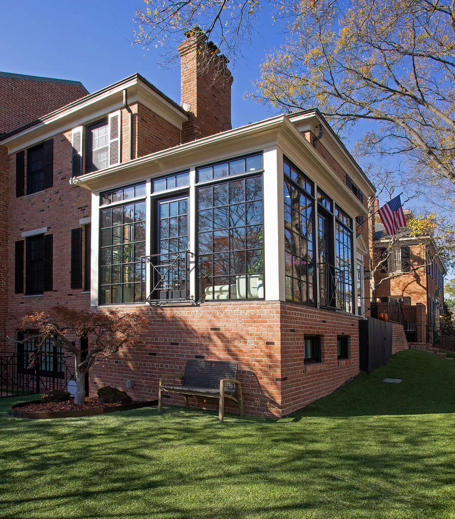 Detailed angle of black-pane sunroom addition on custom brick home by Anchor Remodel in Alexandria, VA