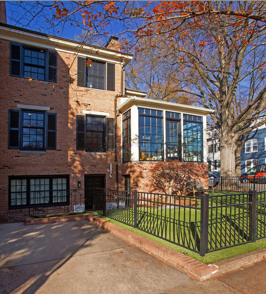 Street-level view of custom sunroom with black window framing by Anchor Remodel in Alexandria, VA