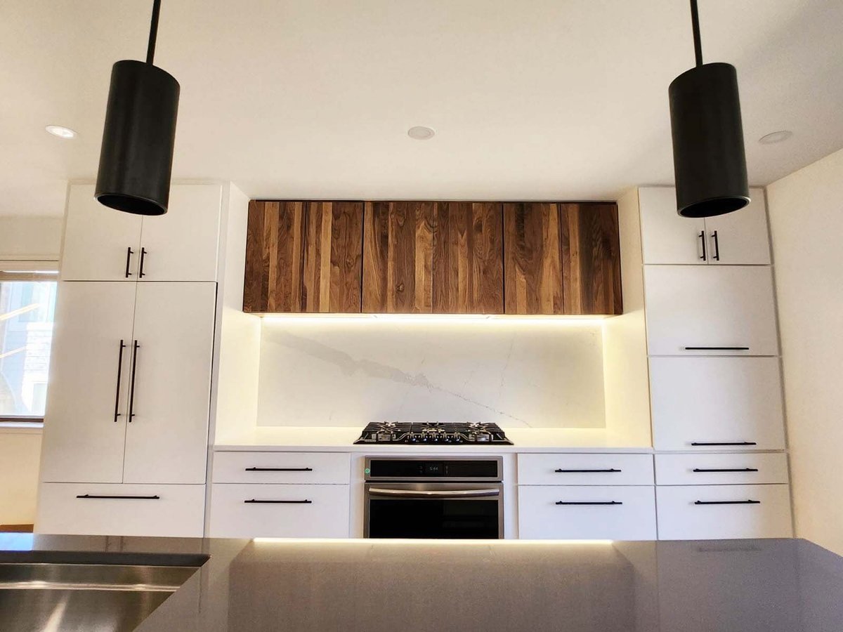 Anchor Remodel kitchen design featuring natural wood upper cabinets and black accents in Alexandria, VA.