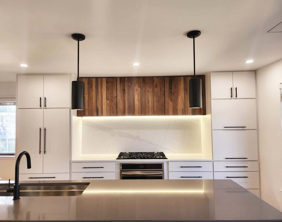Full view of kitchen with walnut cabinets and LED-lit backsplash by Anchor Remodel in Alexandria, VA.