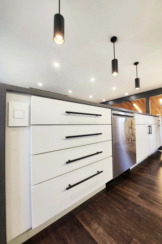 Lower cabinetry and stainless dishwasher in modern kitchen remodel by Anchor Remodel in Alexandria, VA.