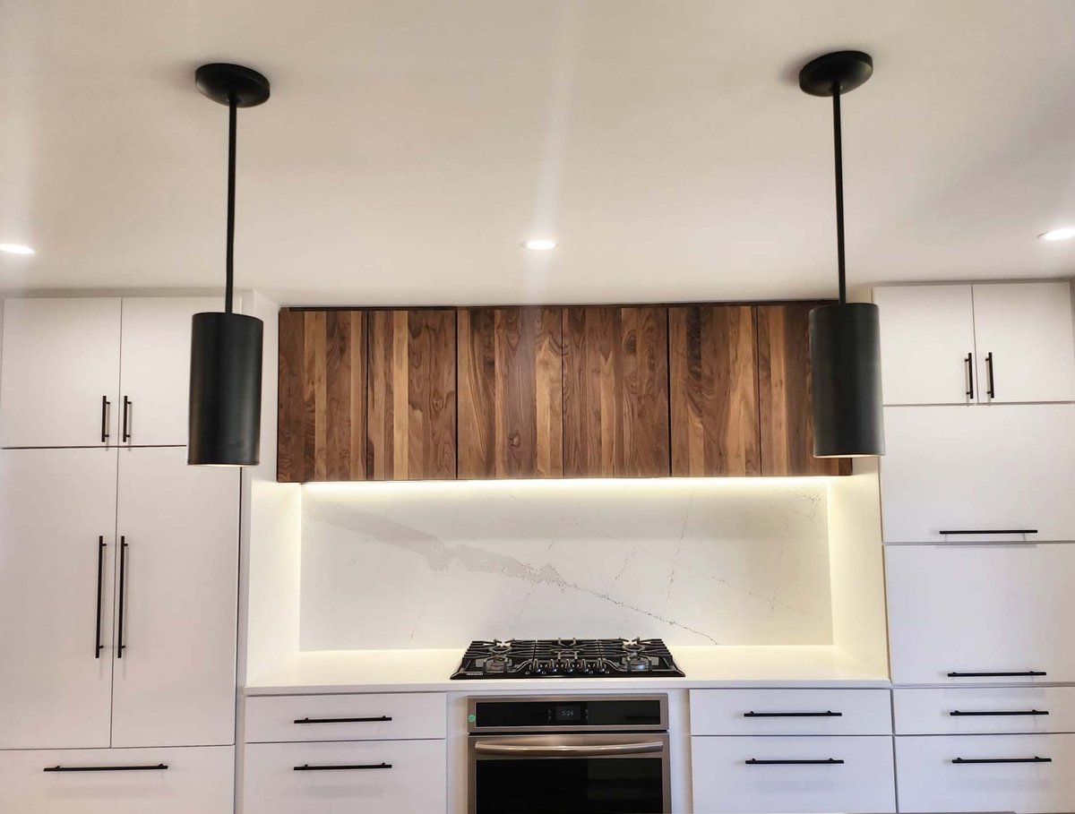 Stylish kitchen renovation with two-tone cabinetry and quartz backsplash by Anchor Remodel in Alexandria, VA.