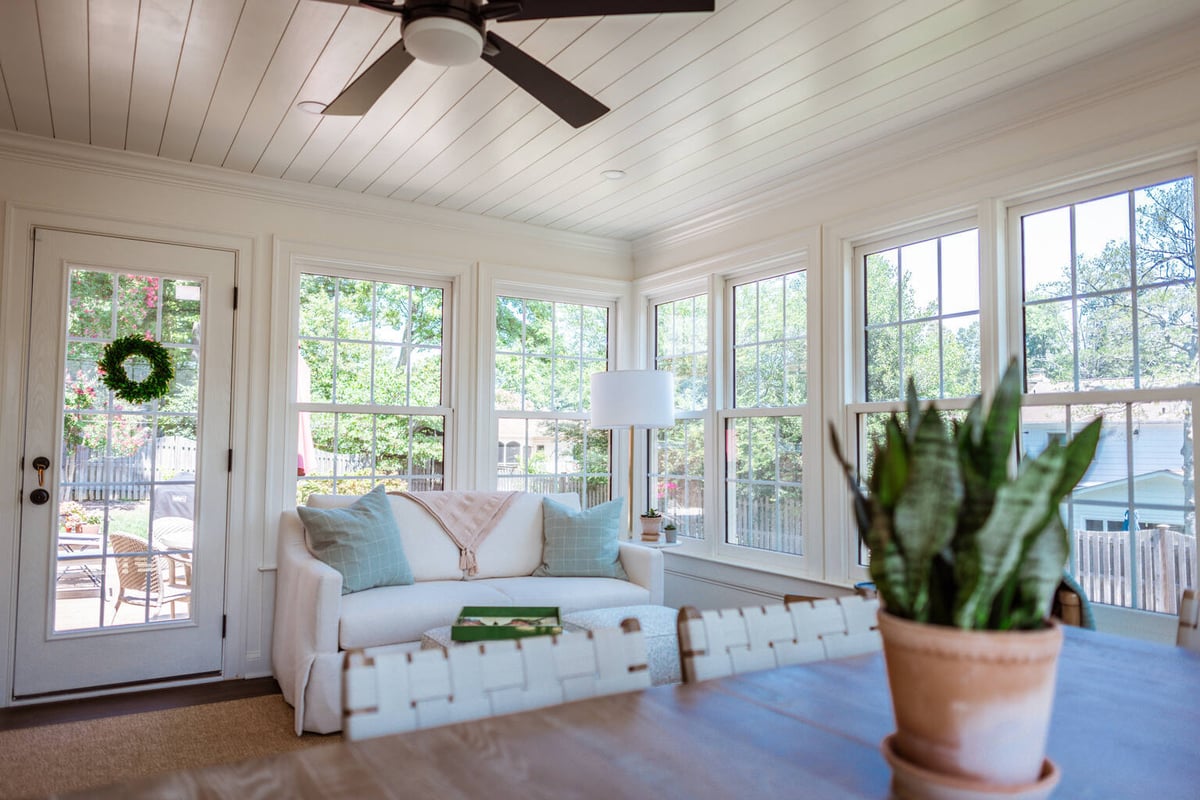 Wide view of custom-built sunroom with ceiling fan and abundant windows by Anchor Remodel in Alexandria, VA