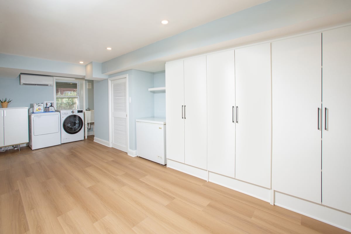 Clean laundry and utility room with ample storage in Springfield custom home by Anchor Remodel.