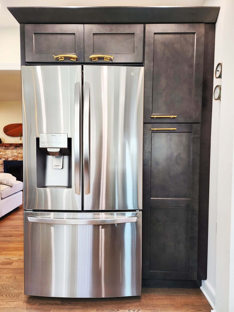 Custom kitchen with sleek fridge integration and storage cabinets by Anchor Remodel in Alexandria, VA
