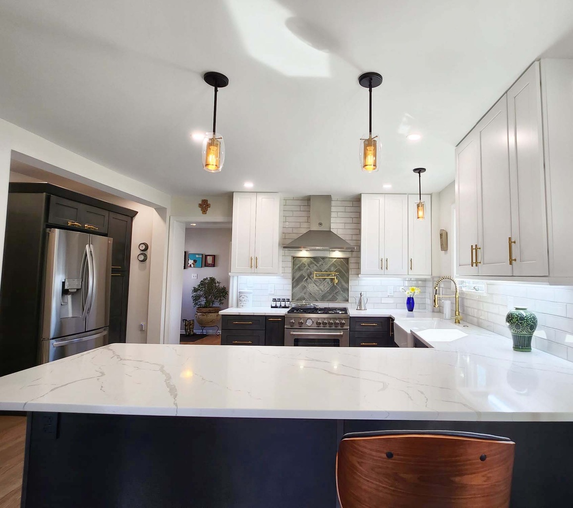 Modern custom kitchen with two-tone cabinets and pendant lighting by Anchor Remodel in Alexandria, VA