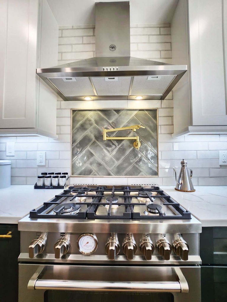 Professional gas cooktop with accent backsplash in kitchen remodel by Anchor Remodel in Alexandria, VA