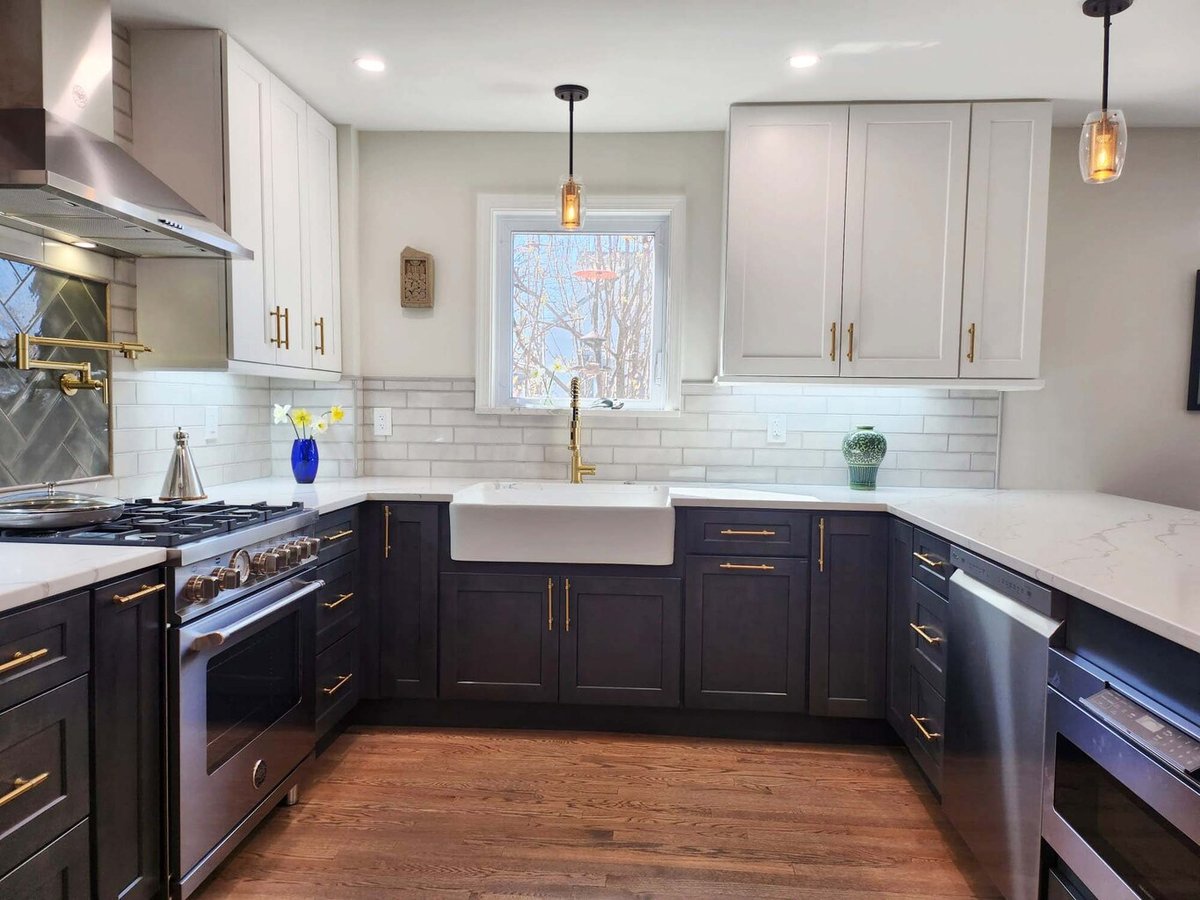 Updated farmhouse sink and tiled backsplash in custom kitchen by Anchor Remodel in Alexandria, VA
