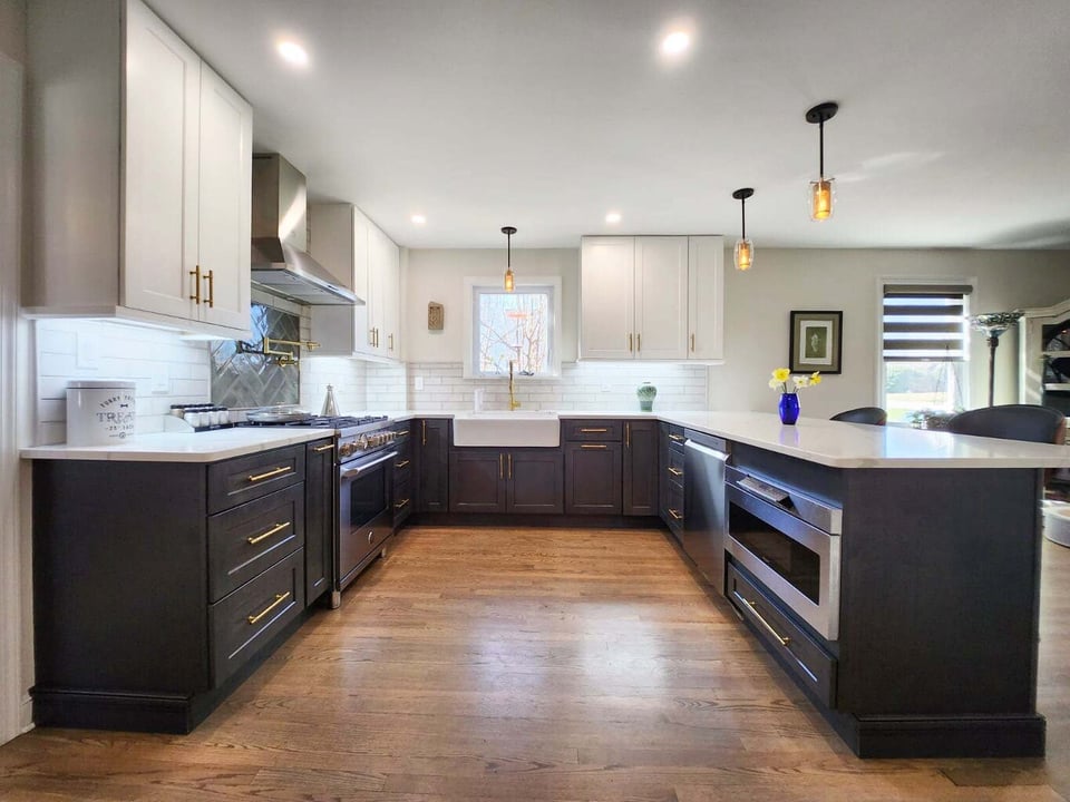 Wide view of kitchen remodel with white uppers and dark base cabinets by Anchor Remodel in Alexandria, VA