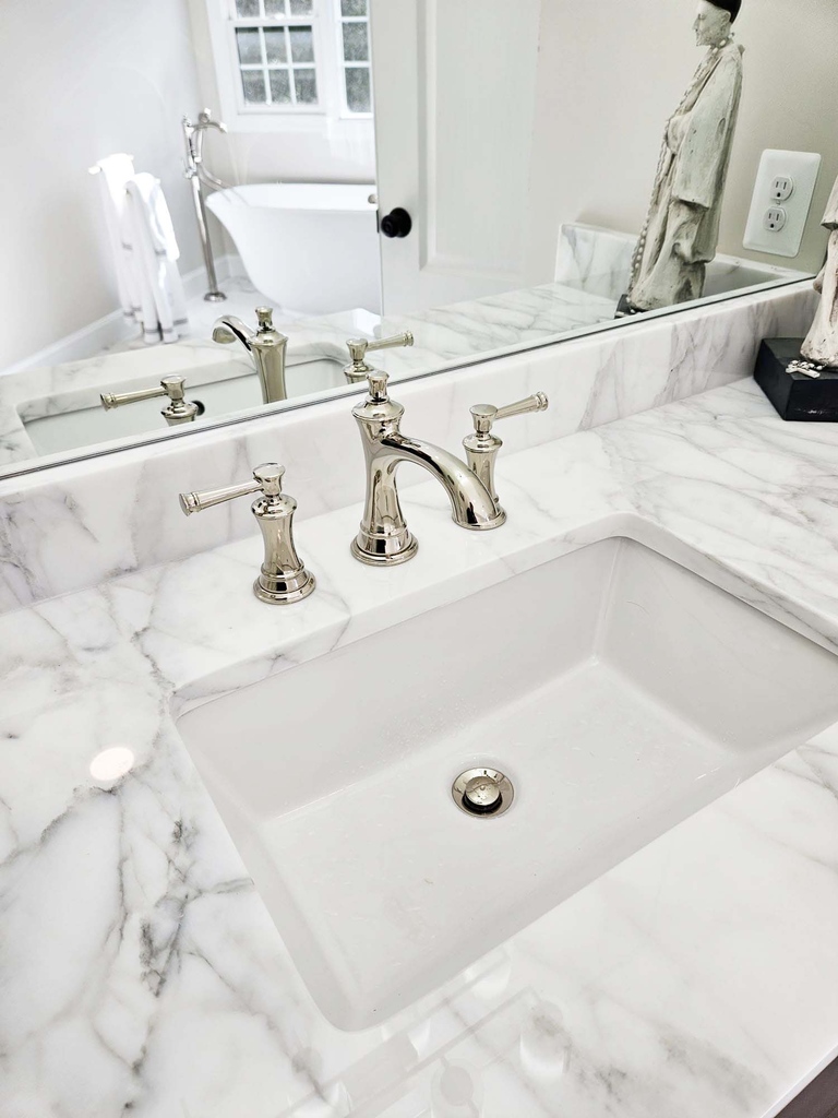 Custom vanity with marble countertop and brushed nickel hardware by Anchor Remodel in Leesburg.