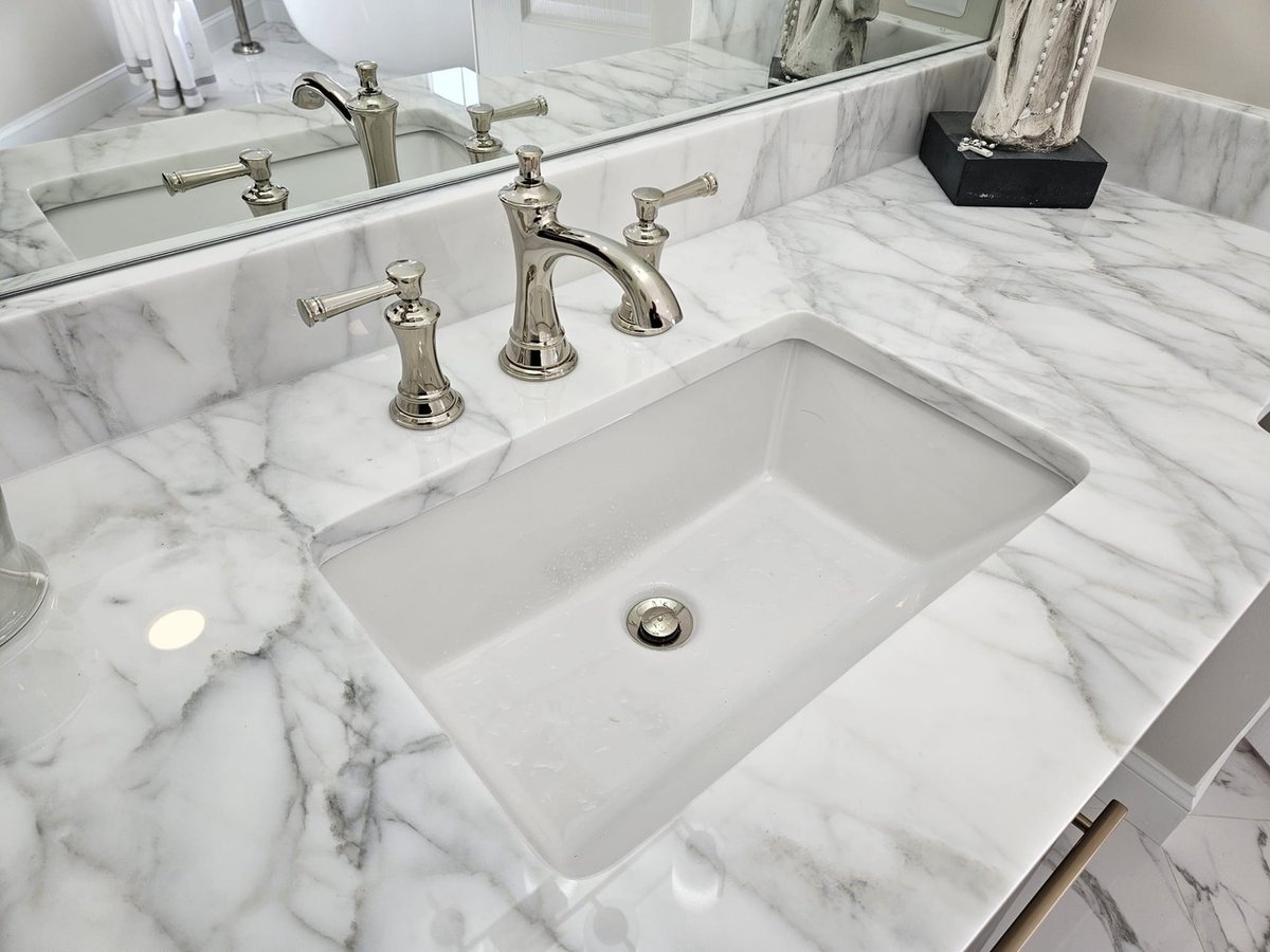 Marble vanity countertop with chrome faucet in Leesburg bathroom by Anchor Remodel.