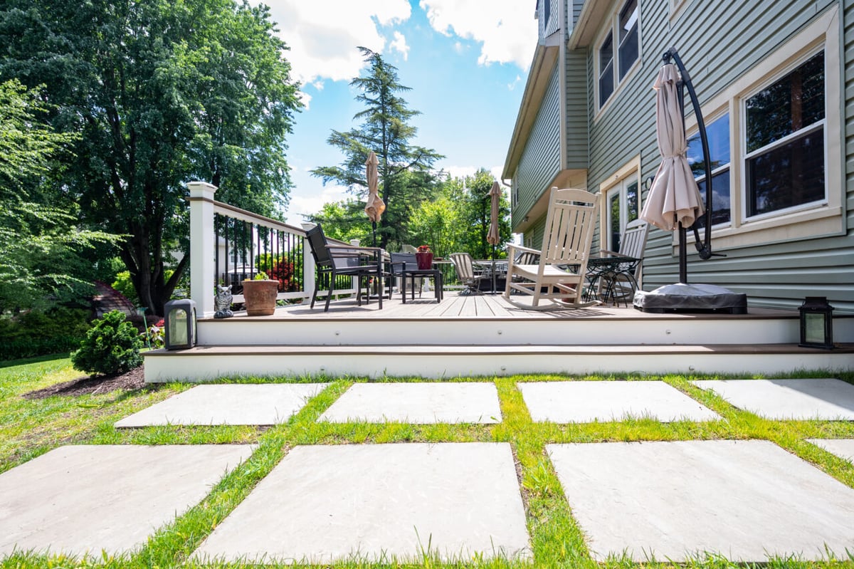 Oversized stone paver walkway leading to a custom Trex composite deck and outdoor seating area in Alexandria, VA