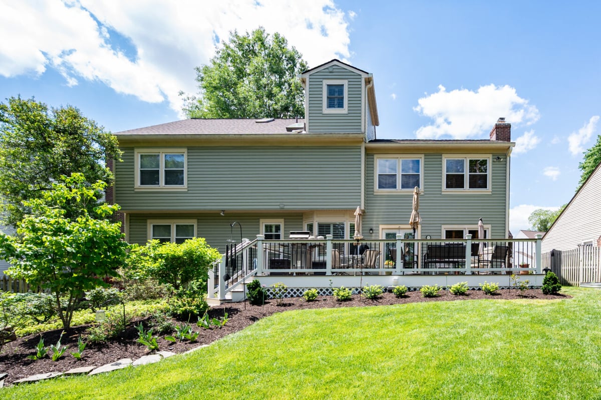 Backyard deck renovation in Alexandria, VA showcasing Trex composite decking, custom railing, outdoor entertaining areas, and professional landscaping.