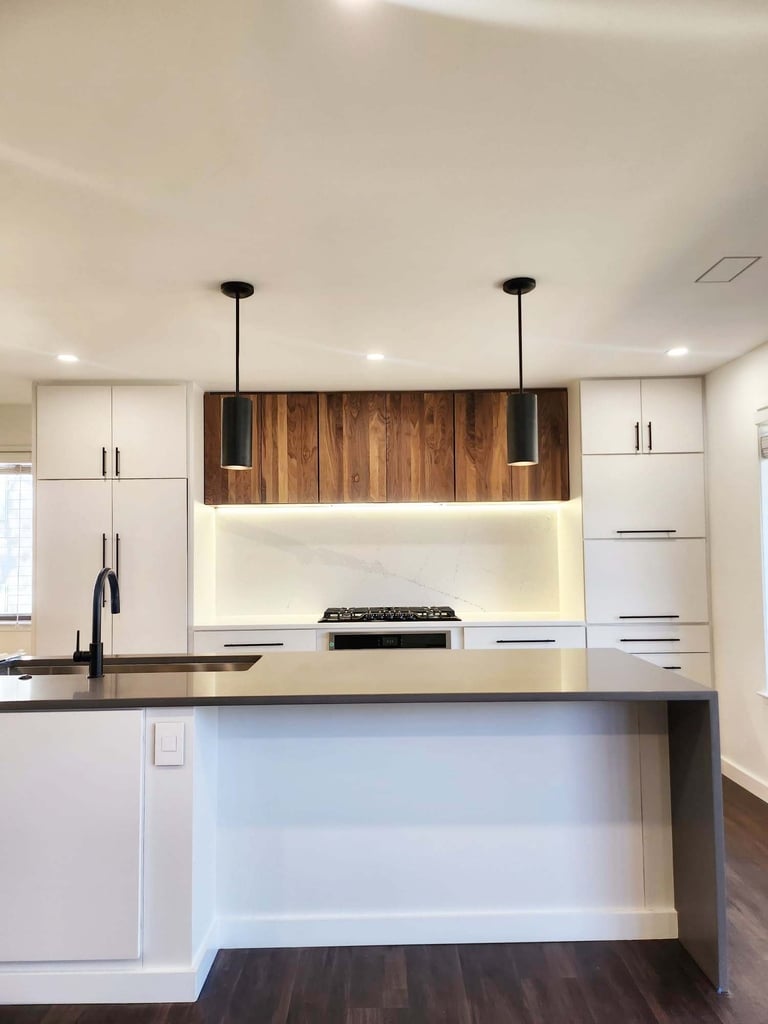 Modern kitchen remodel with flat panel cabinets and dark waterfall island by Anchor Remodel in Alexandria, VA.