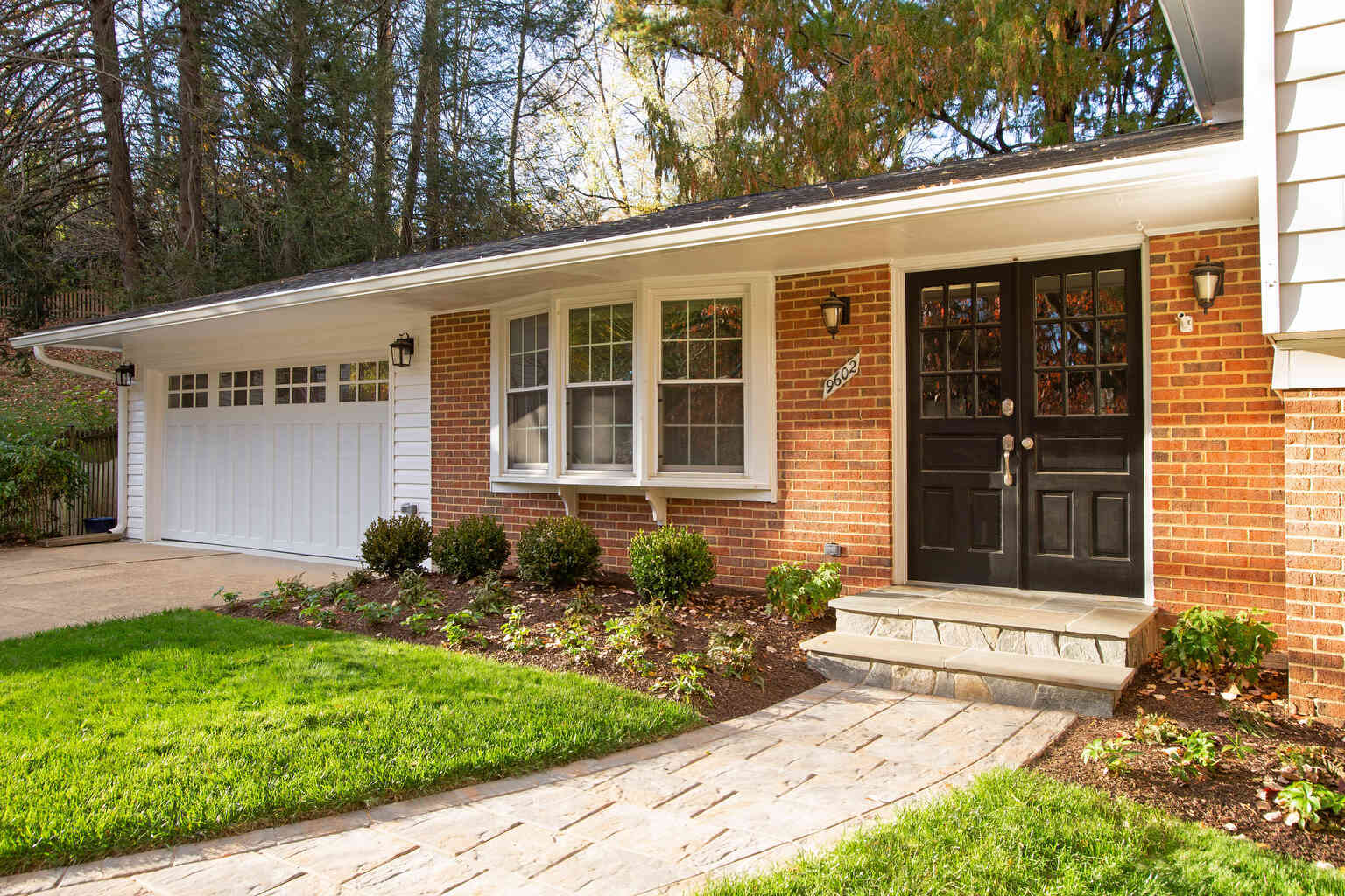 Custom home garage renovation in Vienna, VA with detailed shoe and coat storage by Anchor Remodel.