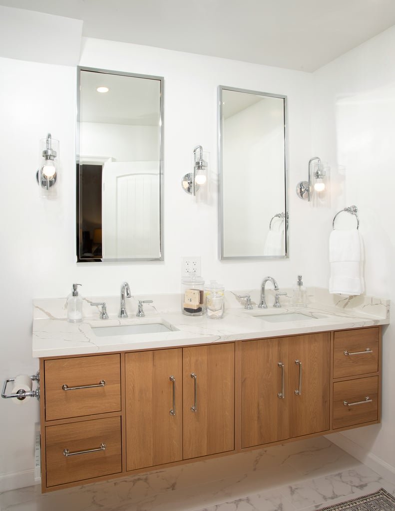 Double sink vanity with wood cabinetry in Vienna master bathroom remodel by Anchor Remodel.