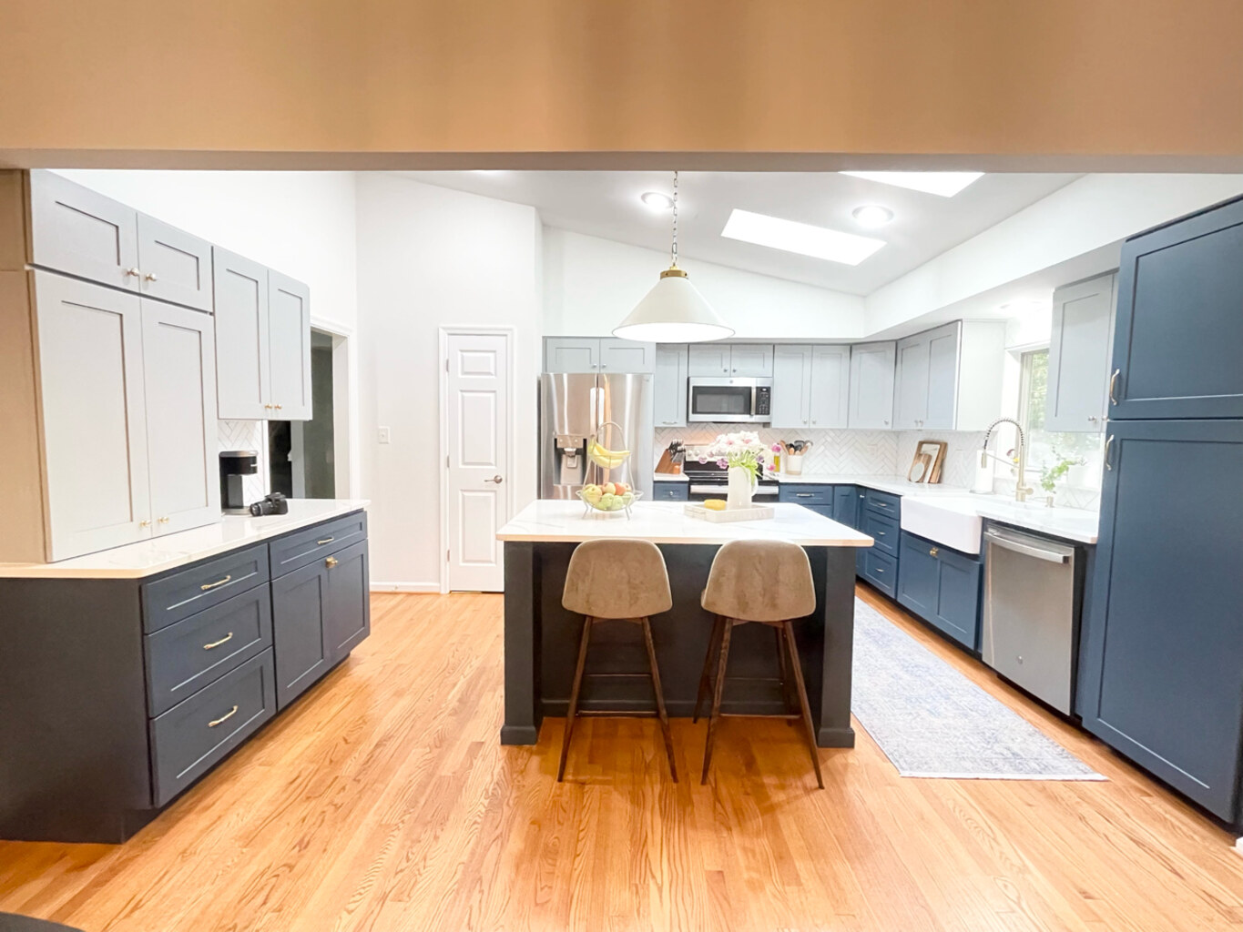 Full kitchen remodel with island and bar stools by Anchor Remodel in Springfield, VA.