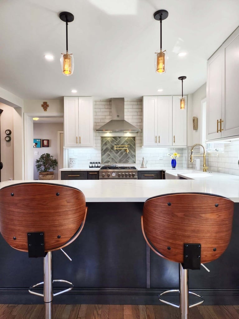 Back view of custom kitchen island with bar stools and pendant lights by Anchor Remodel in Alexandria, VA